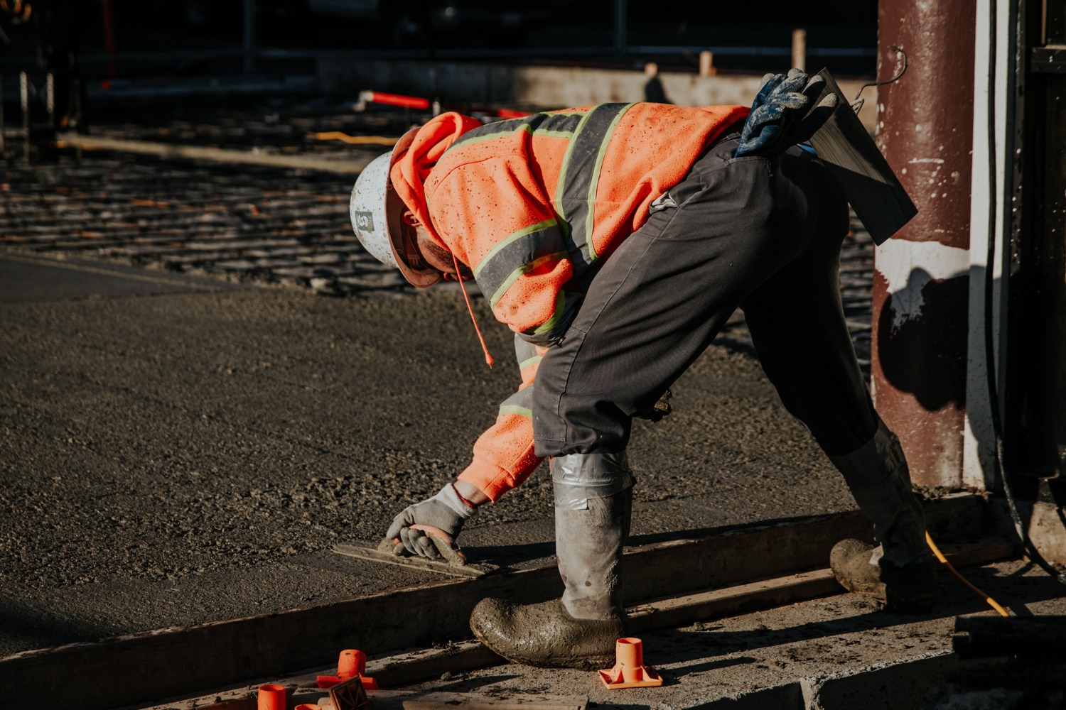 Worker laying fresh asphalt on a Butte County job site